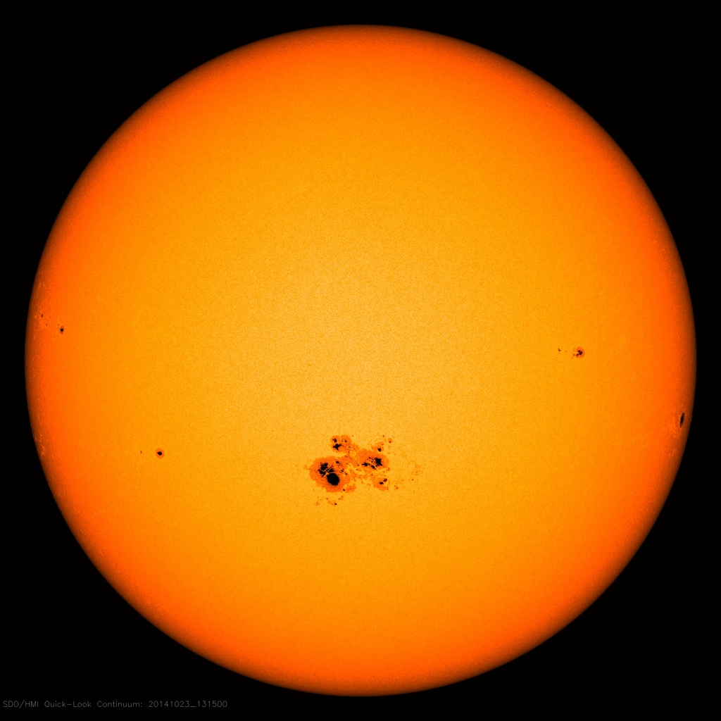 The Sun in visible light with a large sunspot group below the center and a few small spots